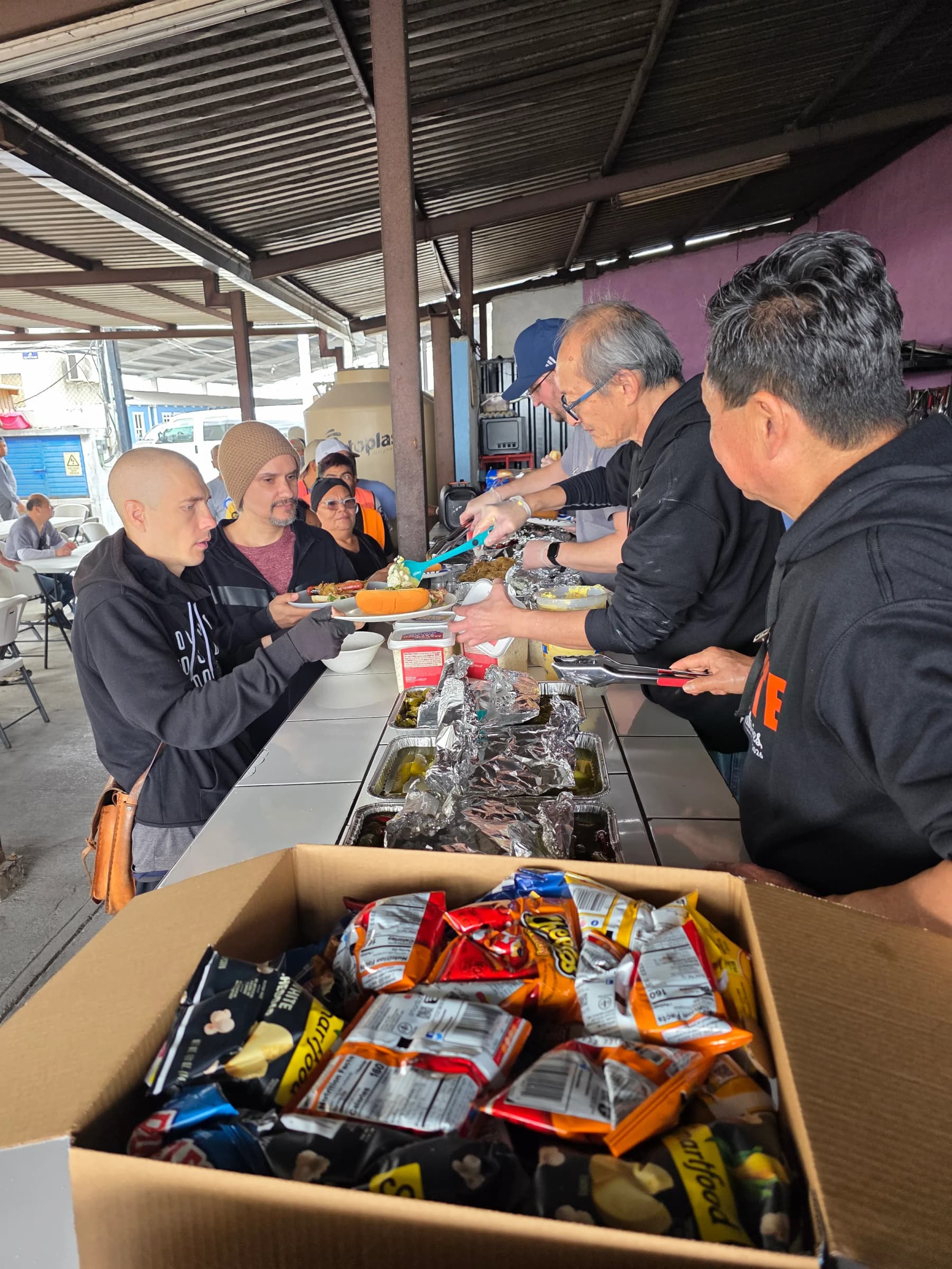 FUERTE volunteers serving meals during a ministry outreach.